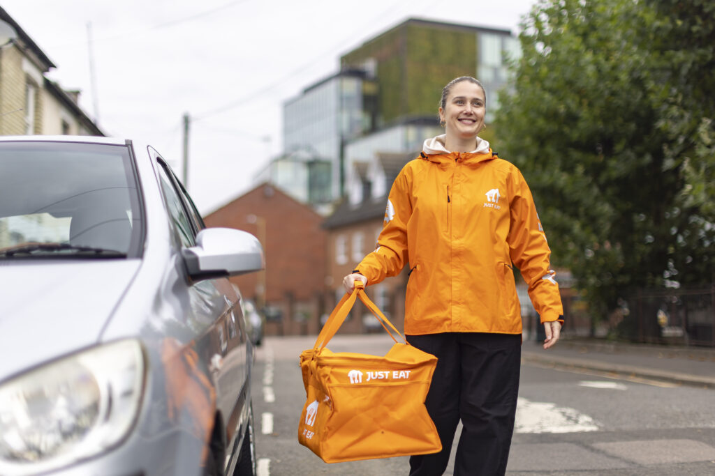 A female Just Eat courier delivering