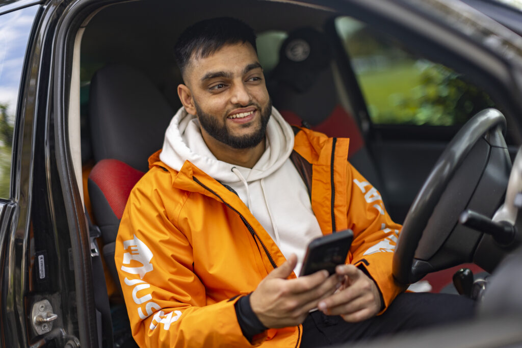 A Just Eat courier in a car