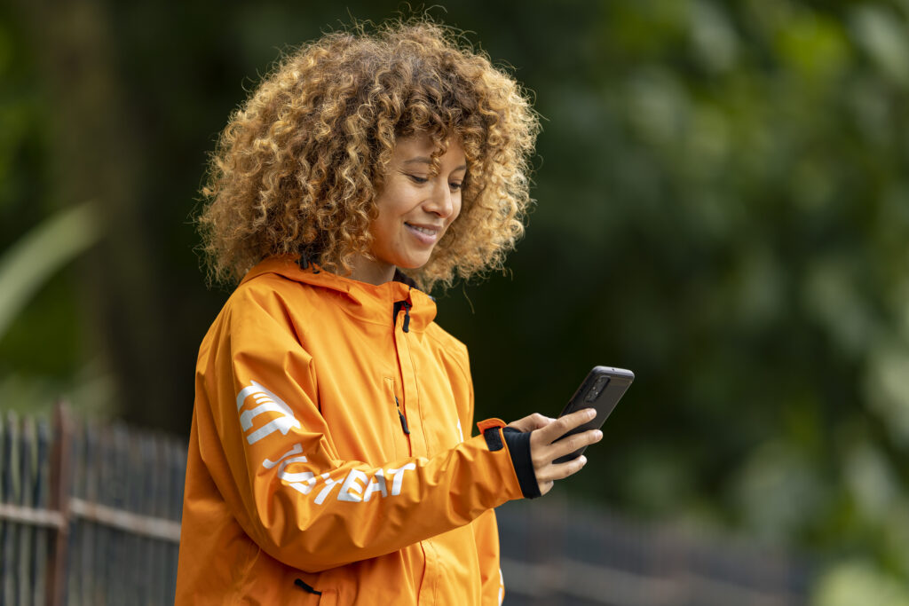 A Just Eat courier checking their phone