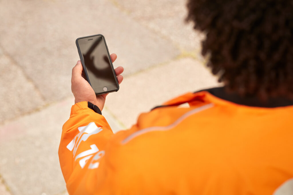 A Just Eat courier checking their phone