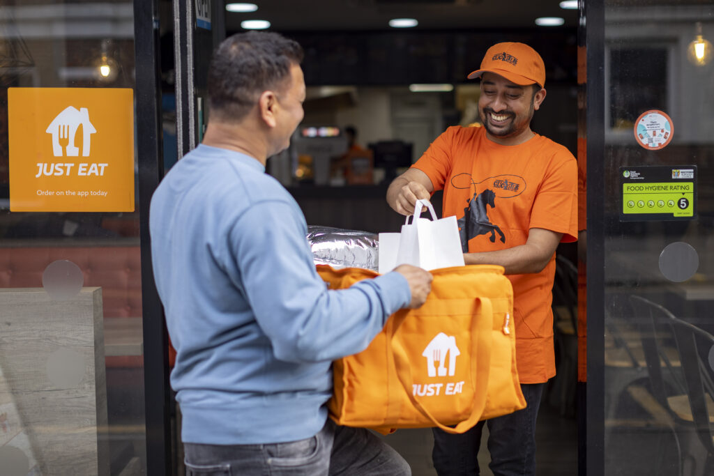 A courier collecting food from a restaurant