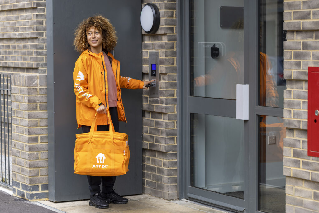 A courier delivering food to a customers' door