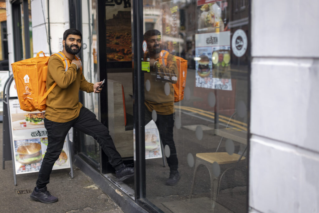 a Just Eat driver delivering at a restaurant