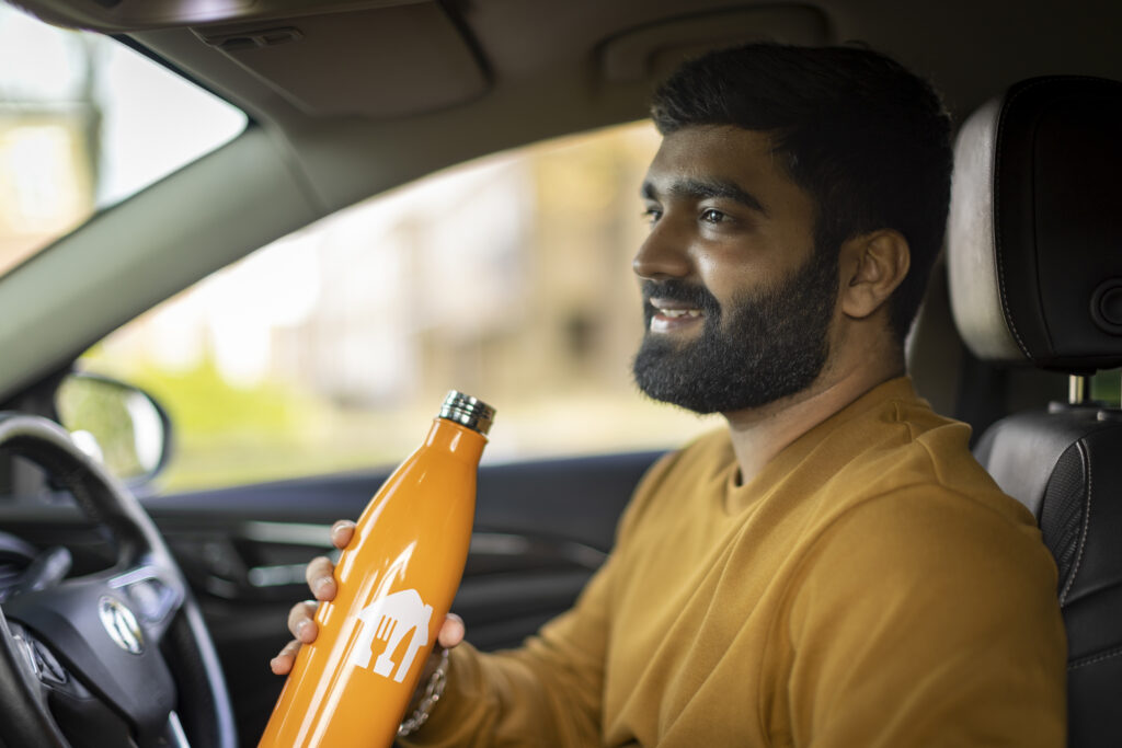 A Just Eat courier in a car