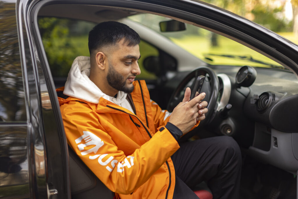 A Just Eat courier in a car