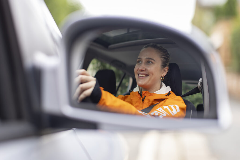 A Just Eat courier driving their car on a delivery